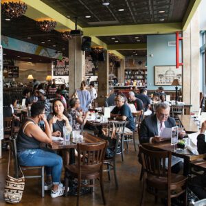 A group of 20 patrons enjoy coffee and pastries inside Signing Starbucks on H-Street on Washington D.C.