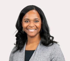 Barbara Robinson, a black woman wearing a grey sweater over a black top, poses for her Clerc Center staff directory. She serves as the Director, School & State Partnerships