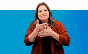 Jill Radford, Director, National Programs & Outreach, signs to camera about the Clerc Center Online Community wearing an orange blazer and black top.